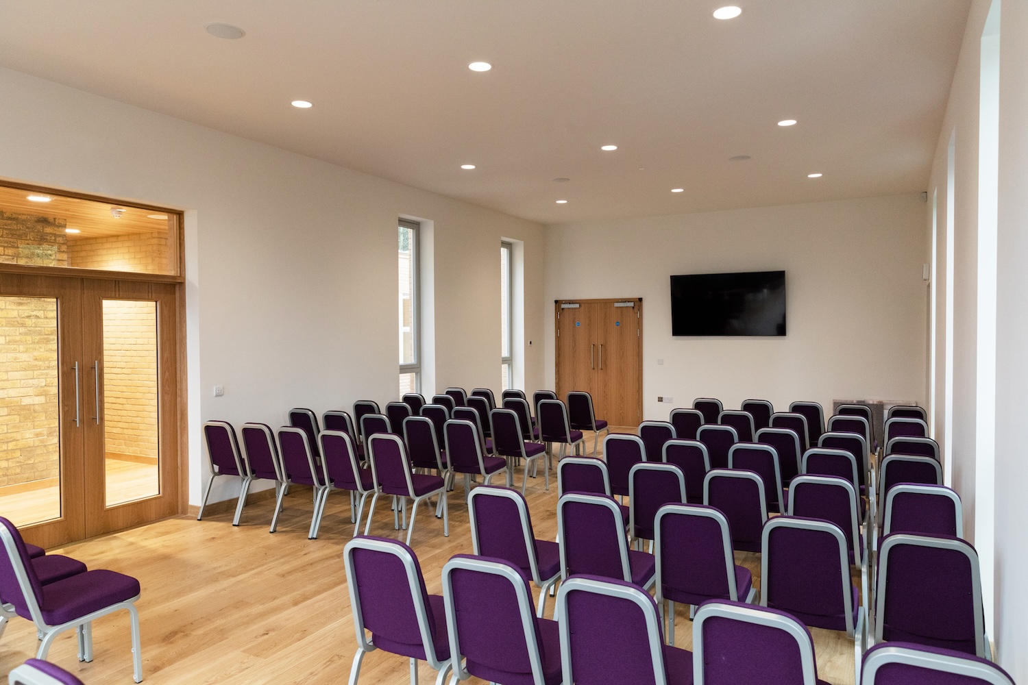A room set up with chairs facing a screen