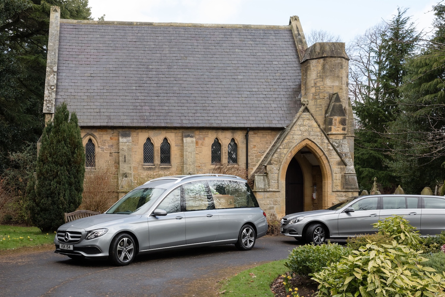 Funeral cars parked outside of a church