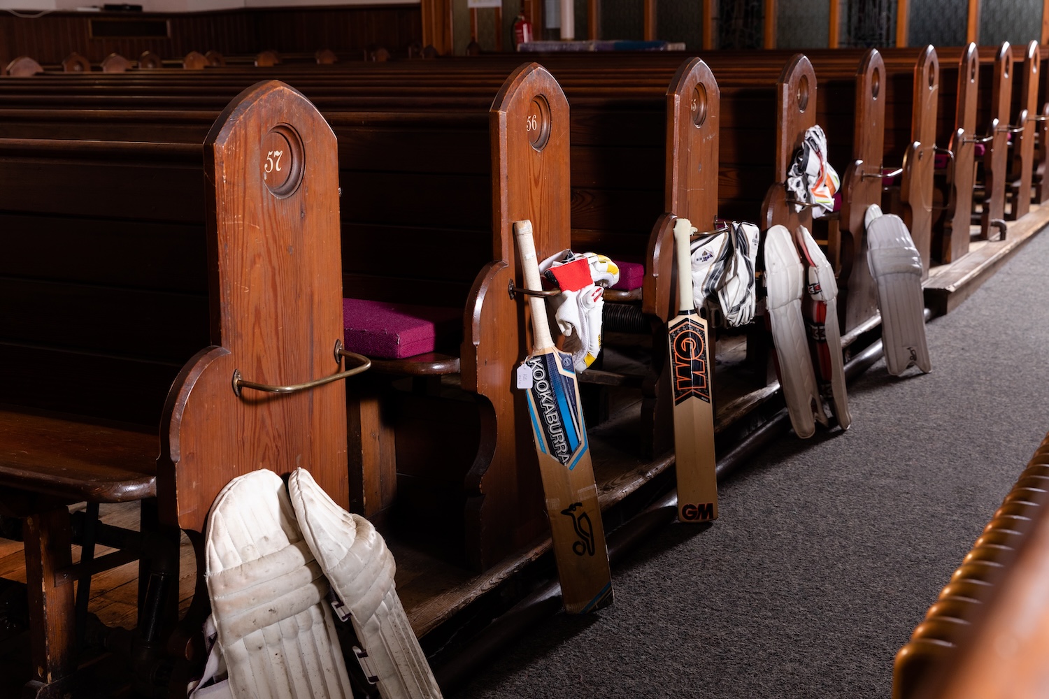 Cricket gear lined up against church pews